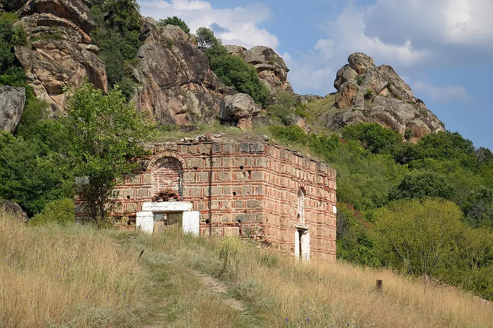 A small ruined medieval brick church among granite boulders in the Varoš quarter of Prilep