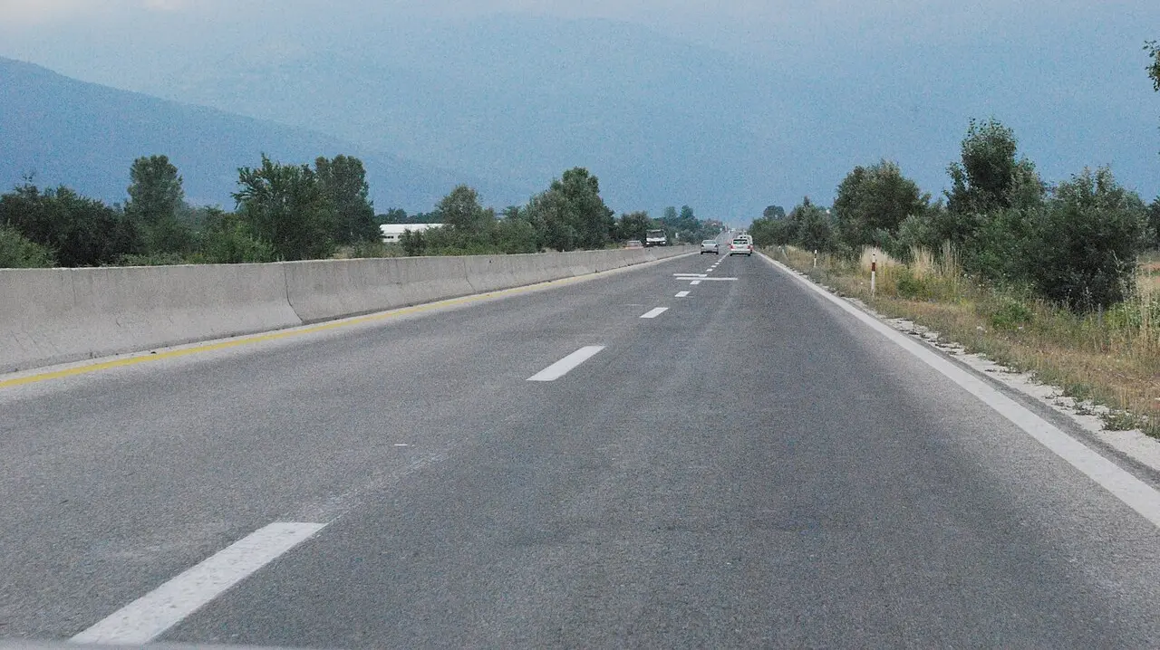 A dual-carriageway motorway in North Macedonia with cars and mountains ahead