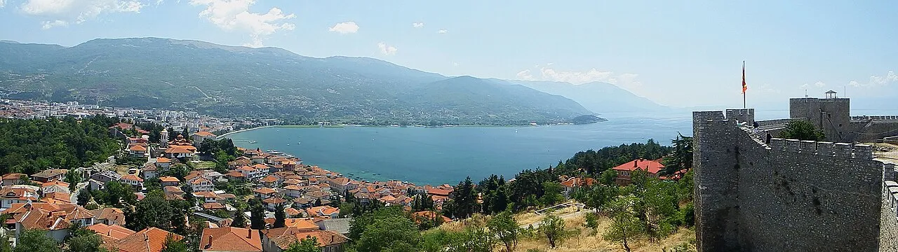 Wide panorama of Ohrid old town and Lake Ohrid from Samuel's Fortress, a tower and the Macedonian flag on the right