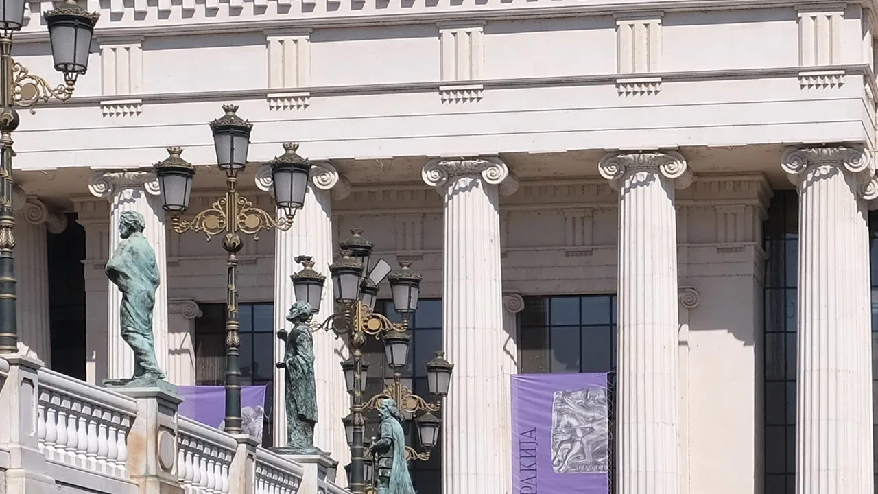 The white neoclassical facade of the Archaeological Museum of North Macedonia beside the Vardar in Skopje