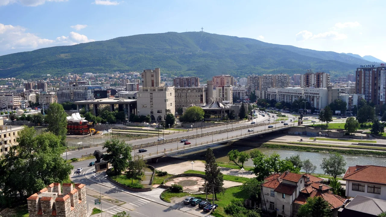 The Goce Delchev Bridge over the Vardar in Skopje, with Mount Vodno and the Millennium Cross on its ridge behind the city