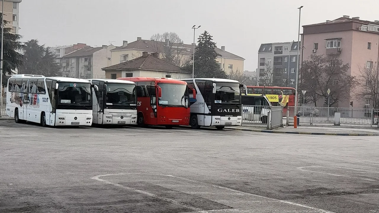Intercity coaches parked in the bays of Skopje's central bus station on a hazy winter afternoon