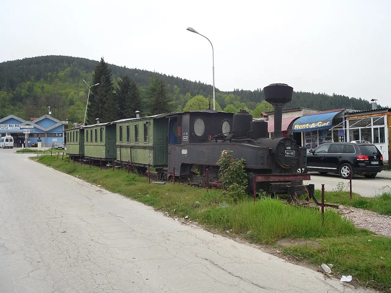 An old narrow-gauge steam train preserved beside the road in Kicevo