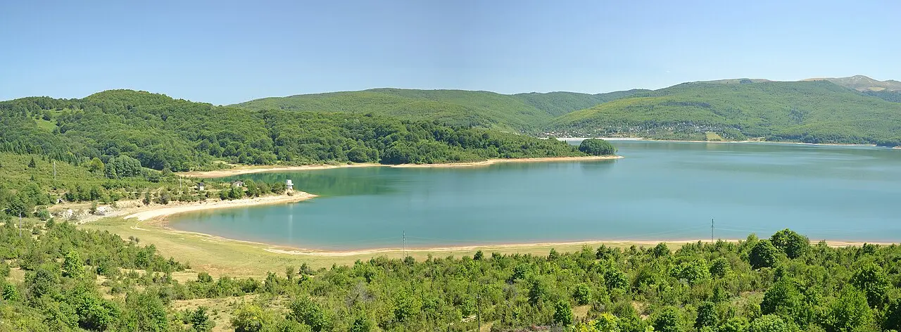 The turquoise water of Lake Mavrovo reservoir ringed by green forested hills