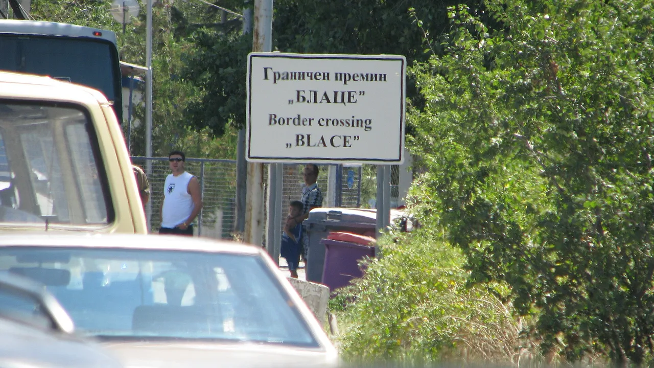 The road sign for the Blace border crossing between North Macedonia and Kosovo, seen from a queue of waiting cars