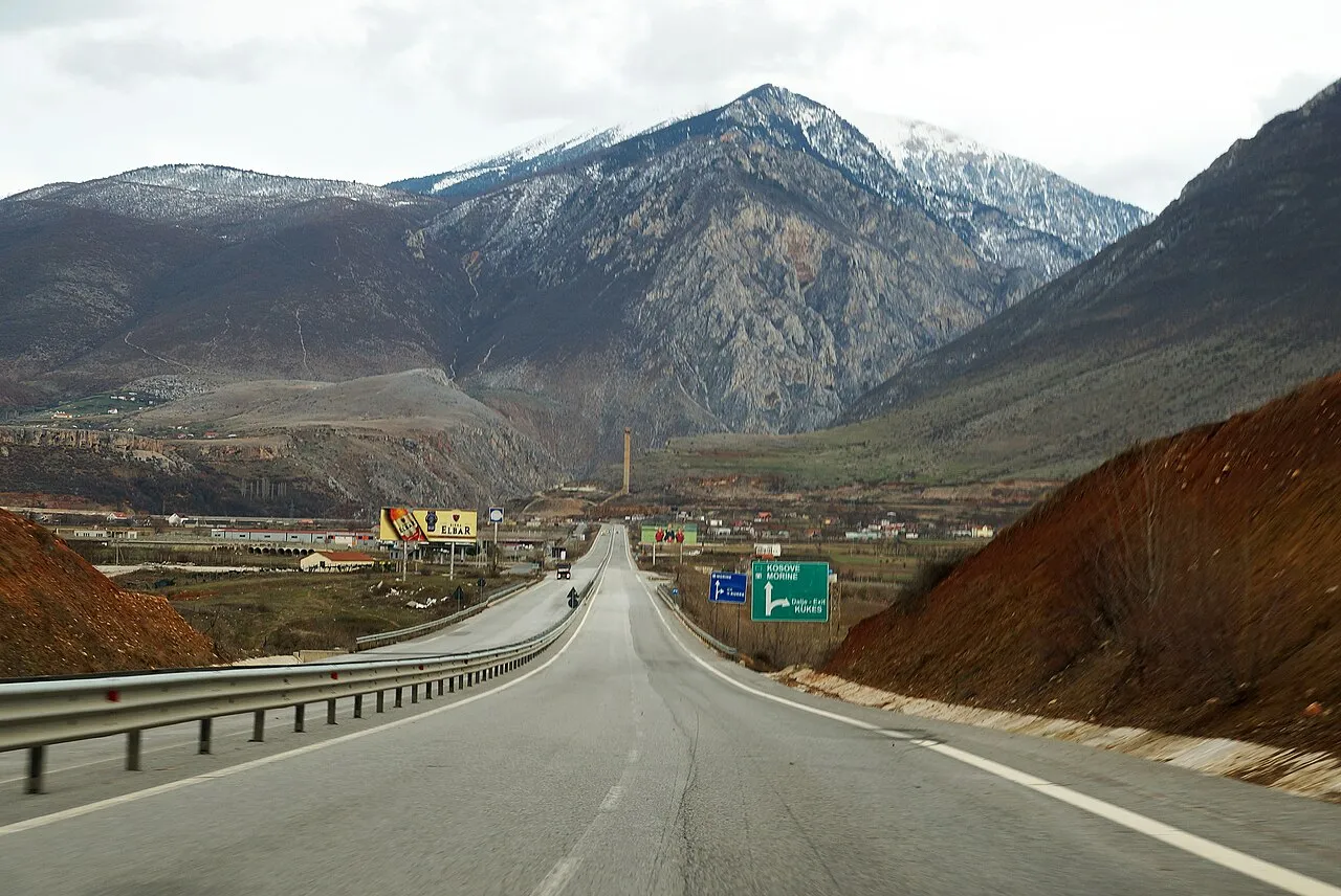 The A1 Rruga e Kombit motorway with a green sign for Kosovo, Morine and the Kukes exit