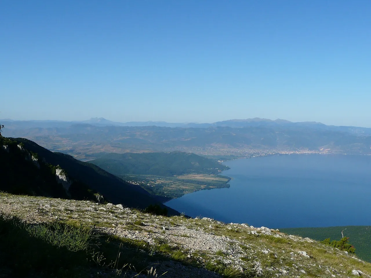 Lake Ohrid seen from high on the Galicica ridge, the far shore and the town hazy below