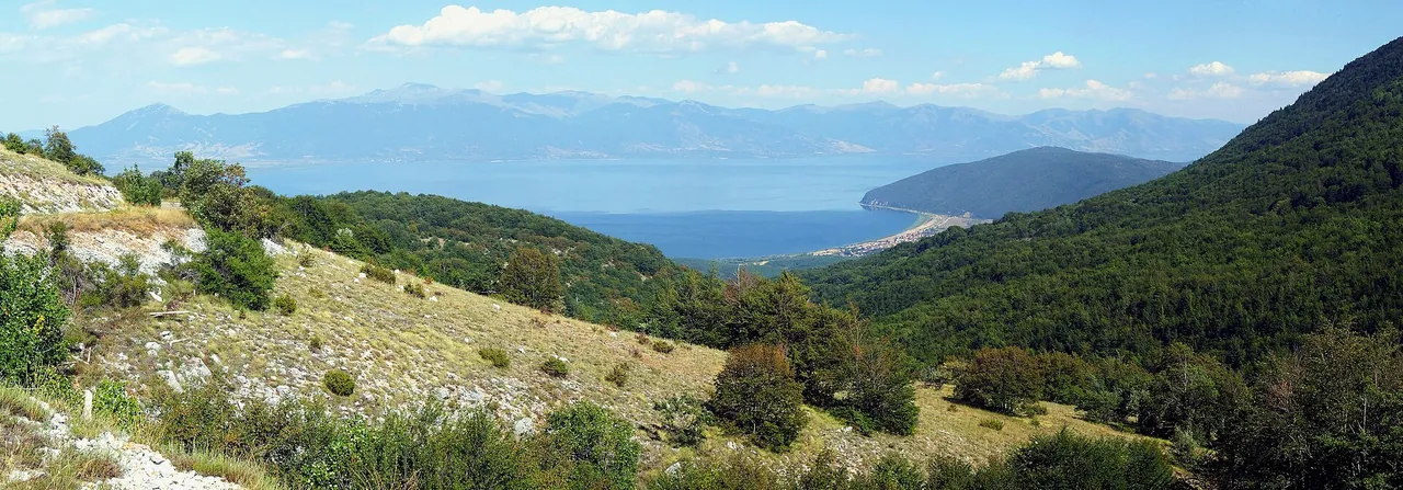 The pebble beach at Stenje on Lake Prespa with mountains across the water
