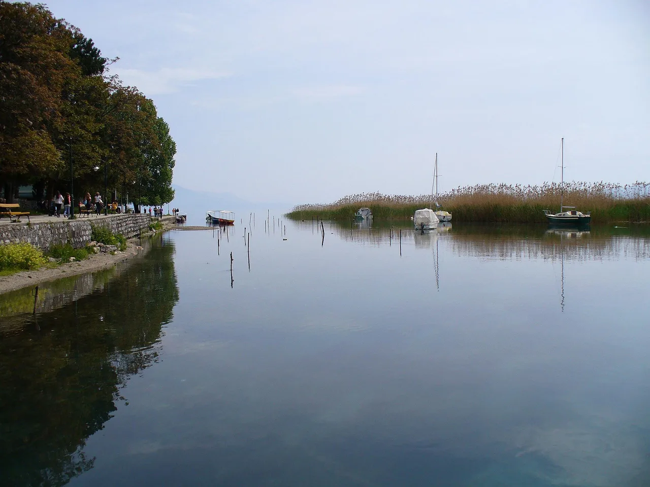 People on a wooden walkway where the Black Drin leaves Lake Ohrid beside Struga