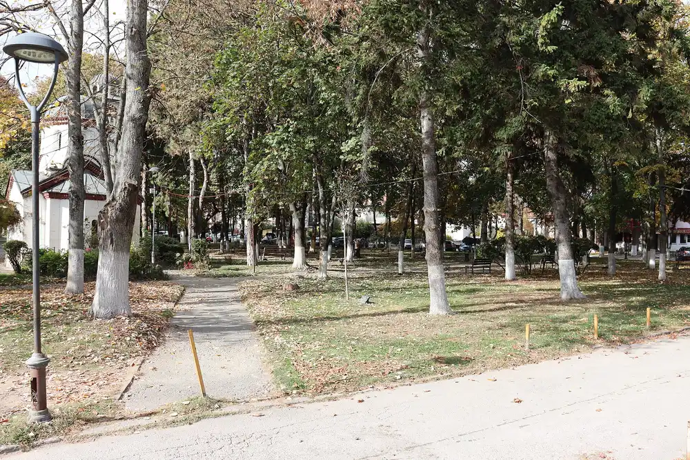 Busts and trees in the Park of Poetry beside a path in Struga