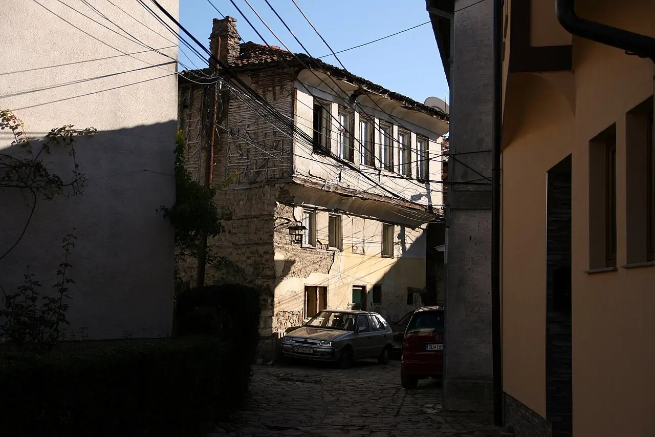 A weathered 19th-century timber-and-stone town house on a cobbled lane in old Struga