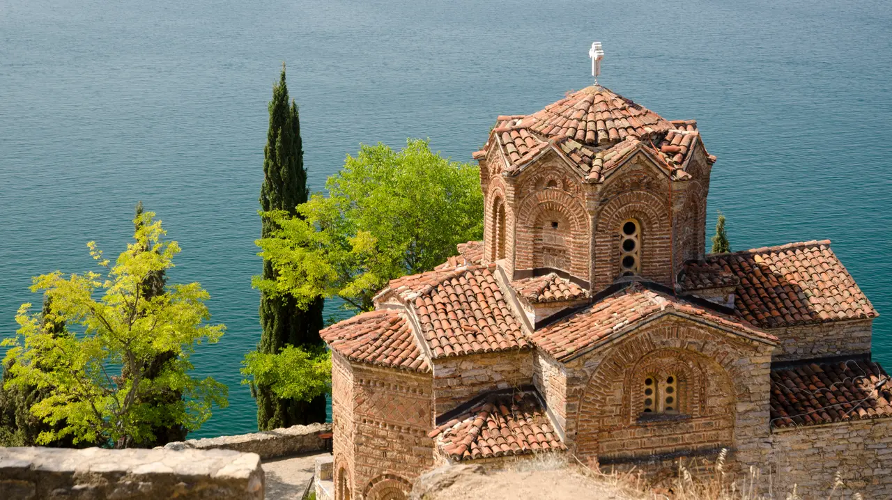 The Church of St. John at Kaneo on its cliff above the blue water of Lake Ohrid