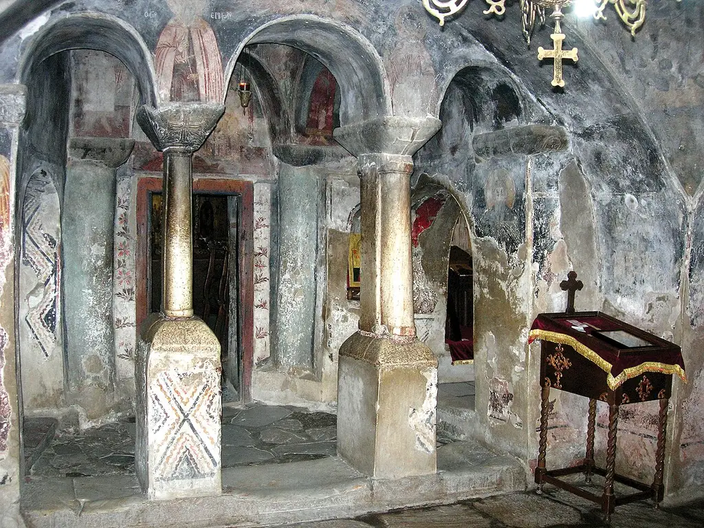 Old frescoes and stone columns inside the church of St. Naum