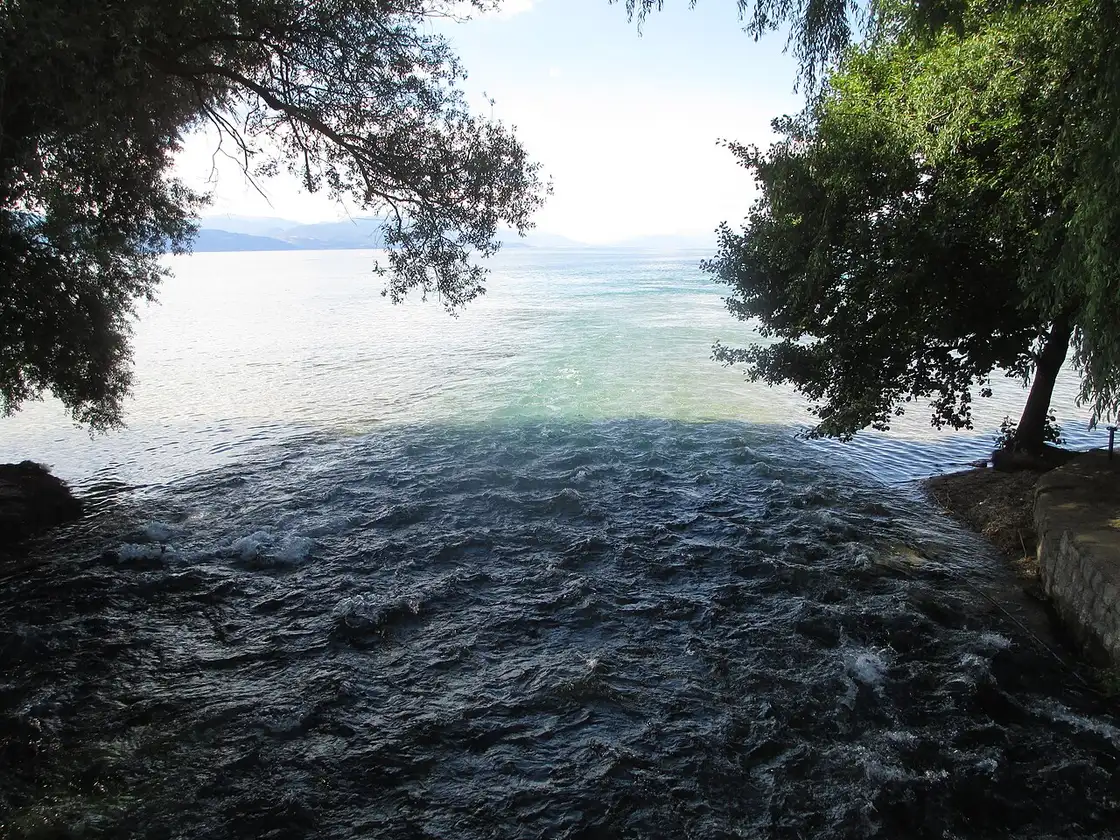 Cold spring water gushing out and mixing into the turquoise of Lake Ohrid