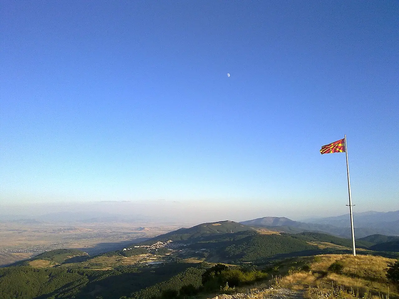 View over Kruševo and the Pelagonia plain with a Macedonian flag on the hillside
