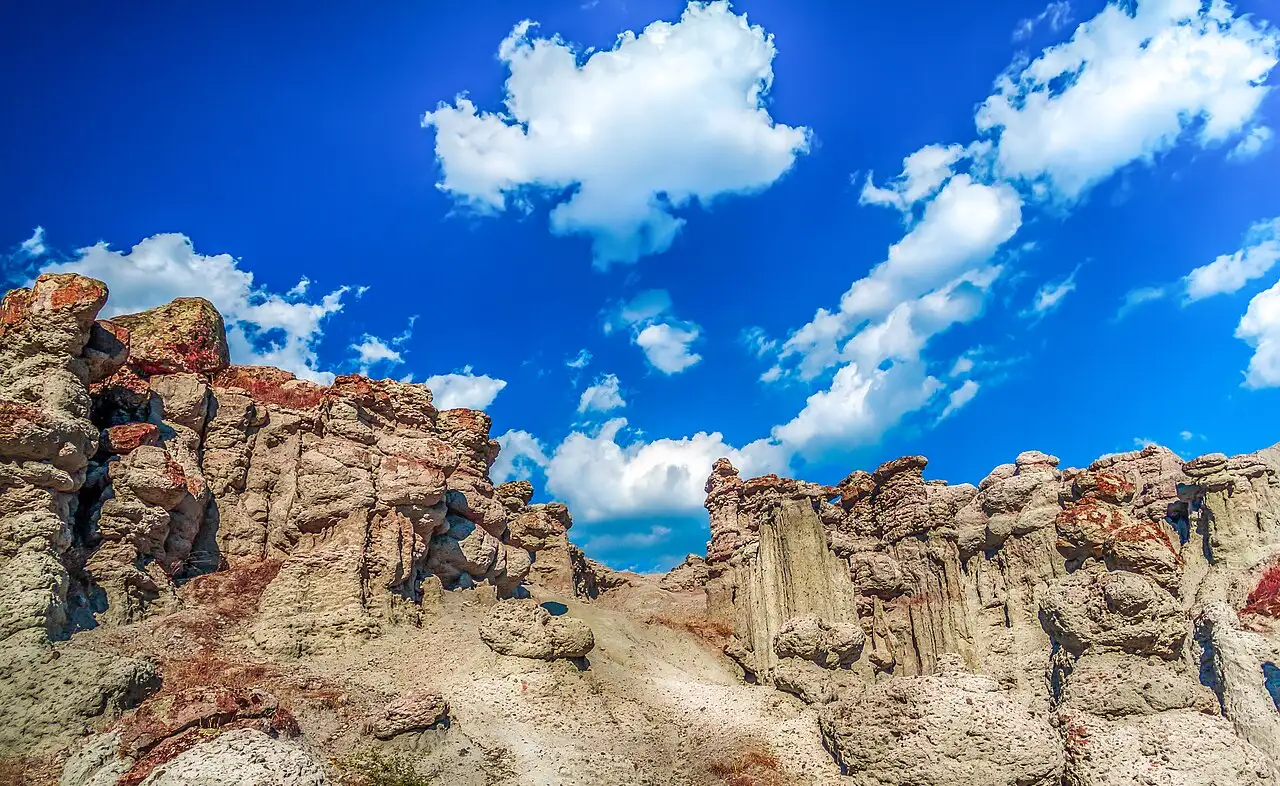 The eroded stone pillars of Kuklica standing against a bright blue sky near Kratovo