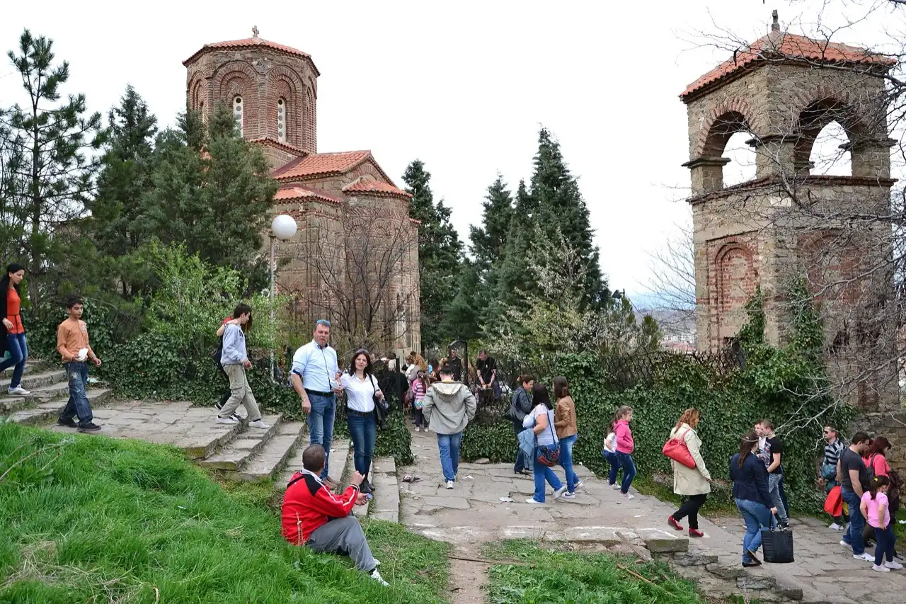 Families and children climbing a path on the Isar hill toward a church during the Chetrse festival in Stip