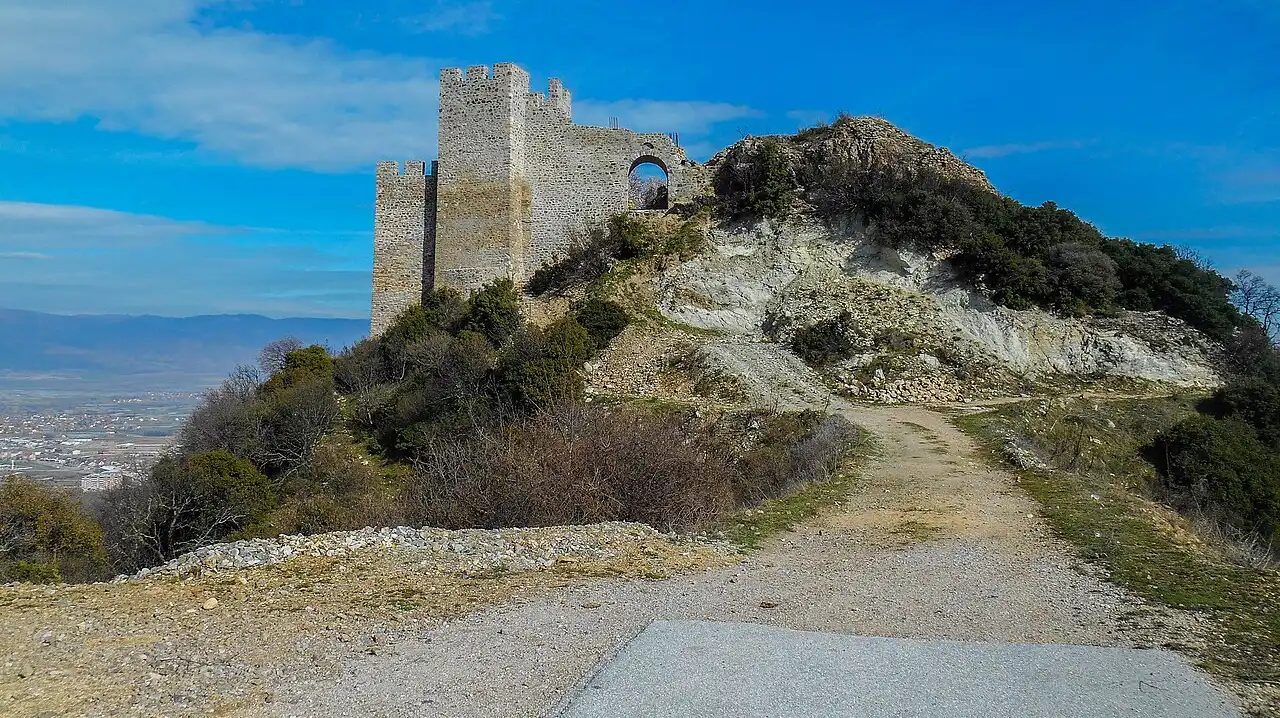 The stone tower of the Carevi Kuli fortress on its hill above Strumica, with the valley and mountains behind