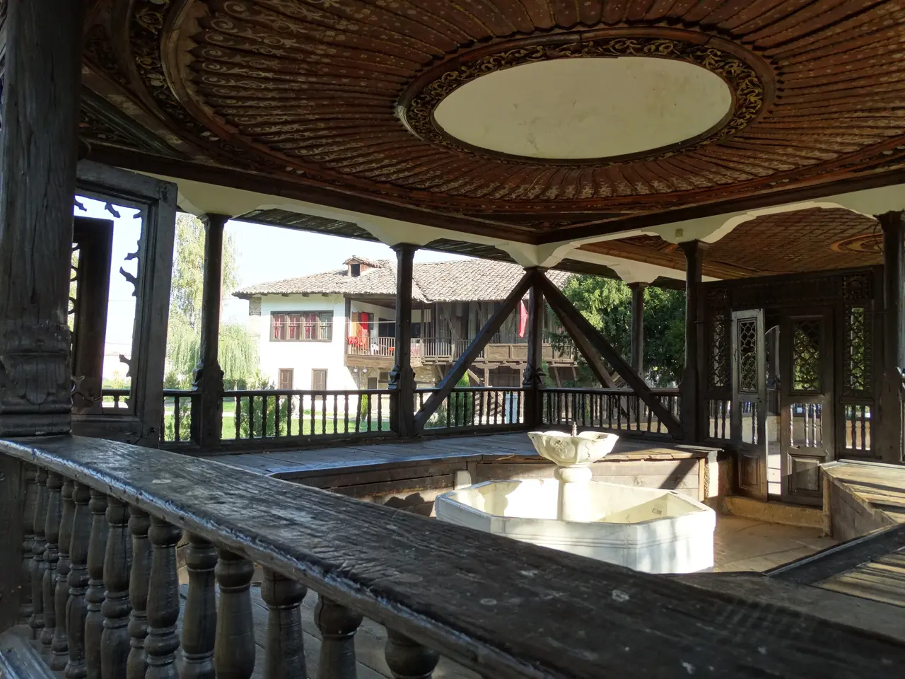 A wooden pavilion over a marble fountain in the courtyard of the Arabati Baba tekke
