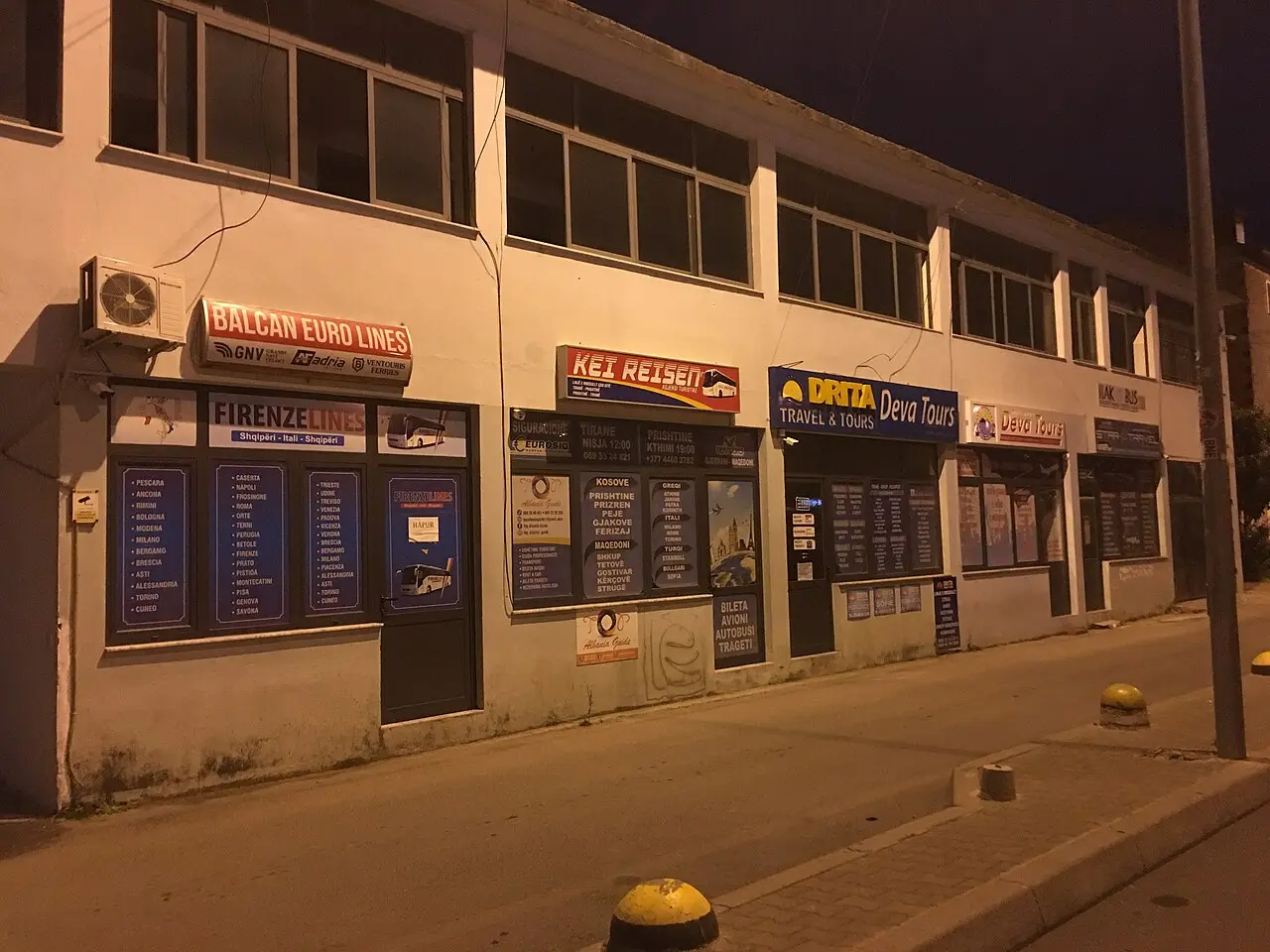 A row of bus-company ticket offices in Tirana advertising routes to North Macedonia and beyond