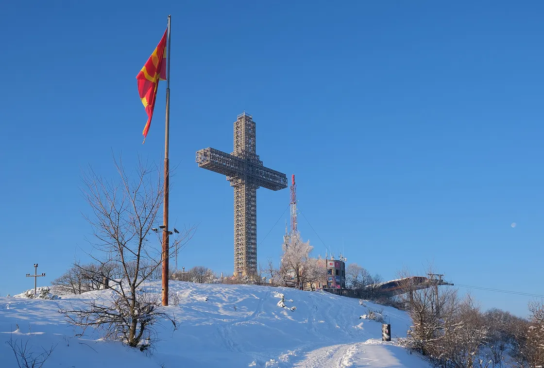The steel lattice of the Millennium Cross rising from its circular base building on the summit of Vodno