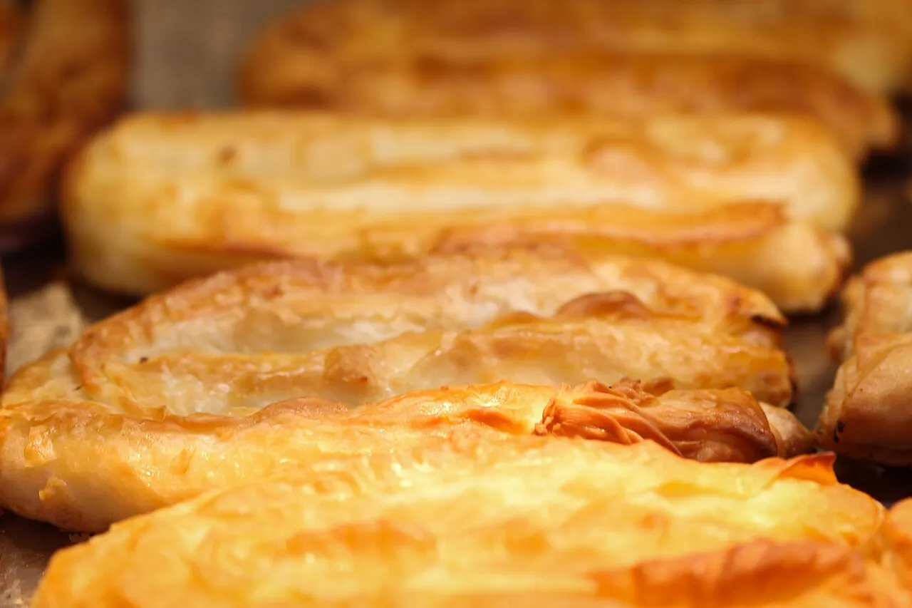 Golden, flaky rolls of maznik cheese pastry fresh from the oven