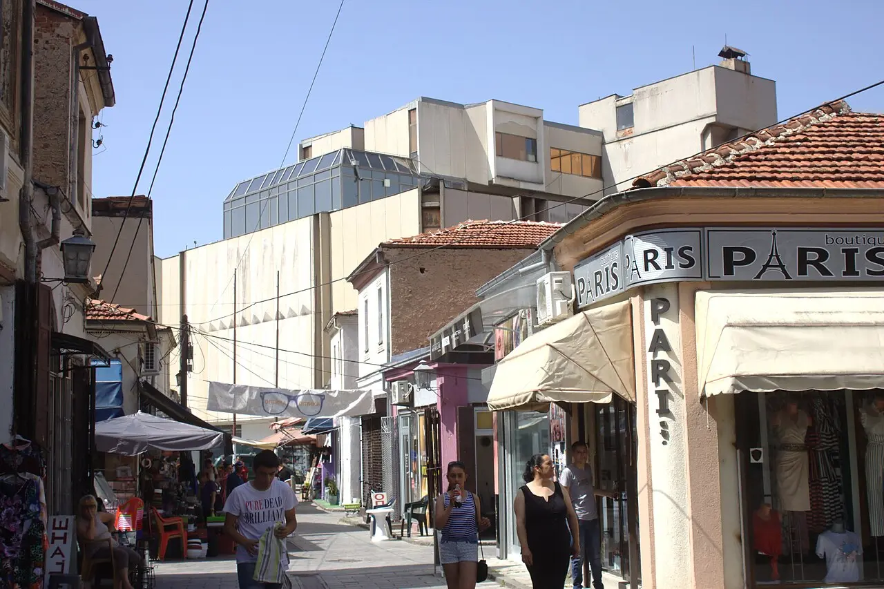 A lane in the Old Bazaar of Bitola with small shops, awnings and people walking between stalls