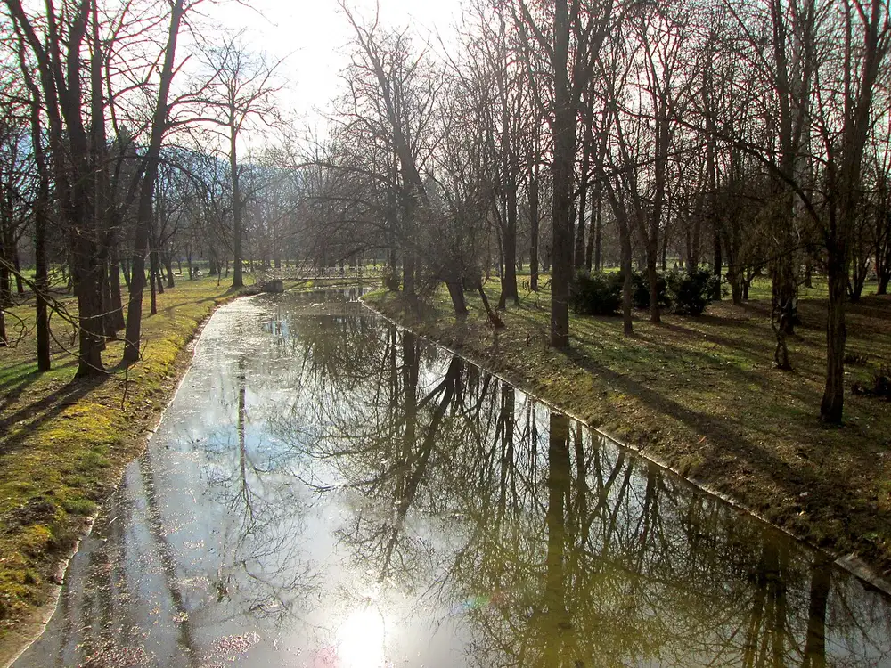 Tree-lined paths and a watercourse in Skopje's City Park (Gradski Park) on a quiet day